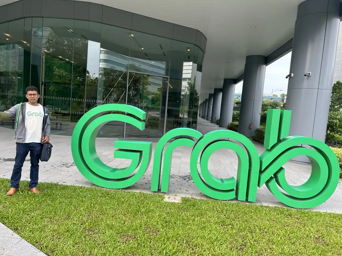 Aditya next to the Grab sign