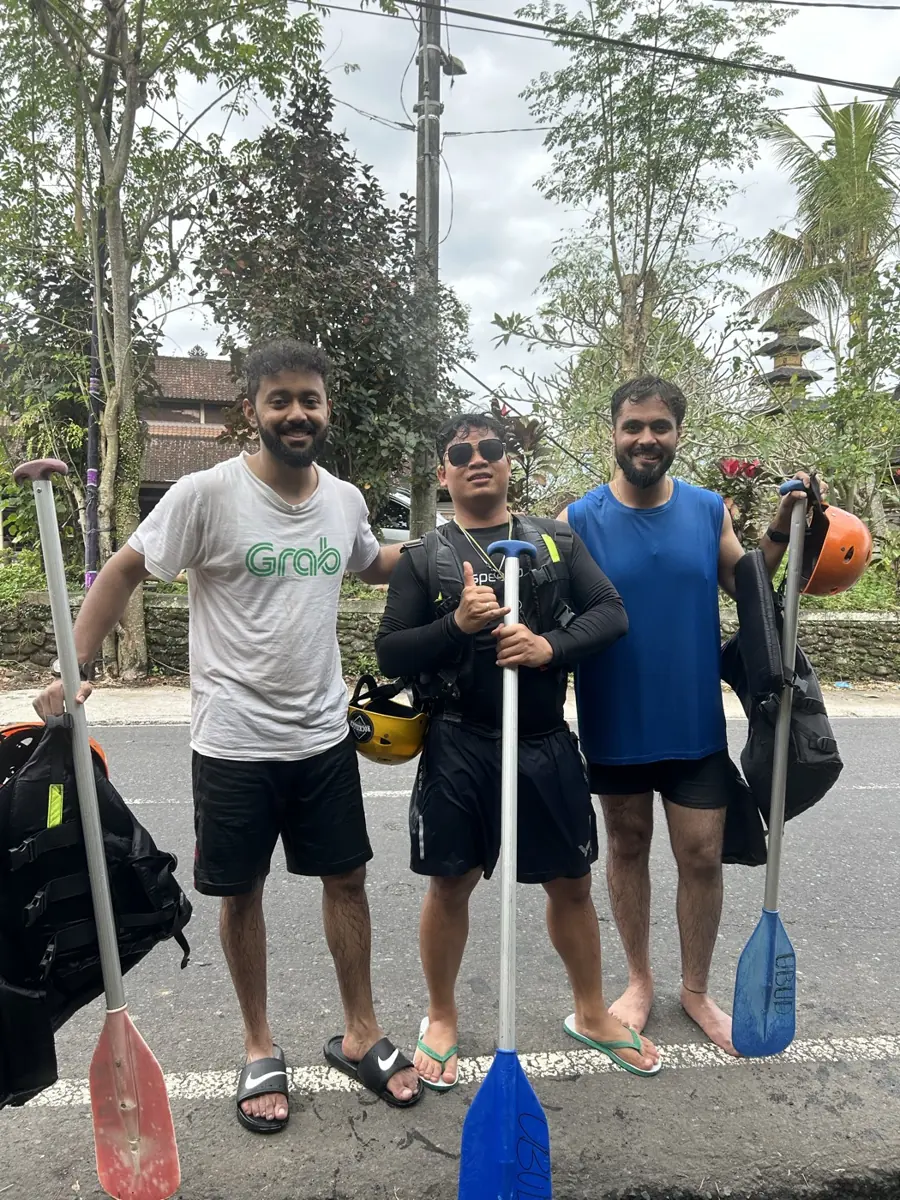 Colleagues with paddles before rafting